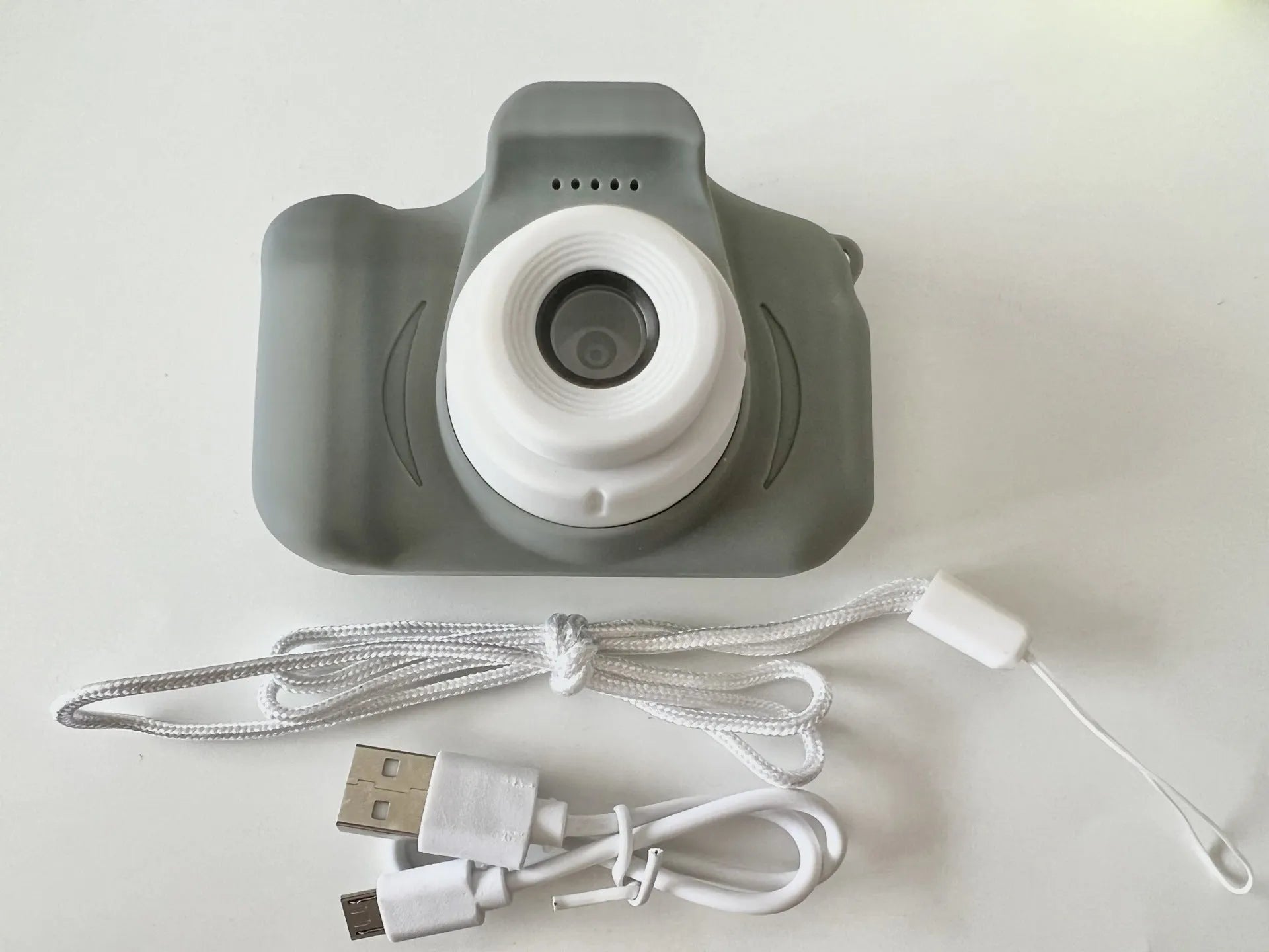 X2 HD mini cartoon kids digital camera in silicone body with 2-inch screen and lanyard.