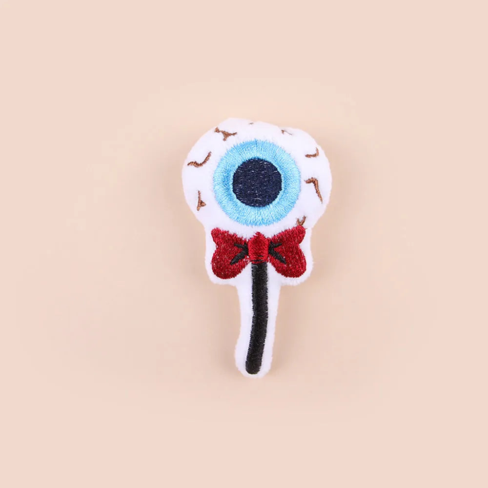 Plush cat teaser toy with feather wand in candy or skull design for small cats