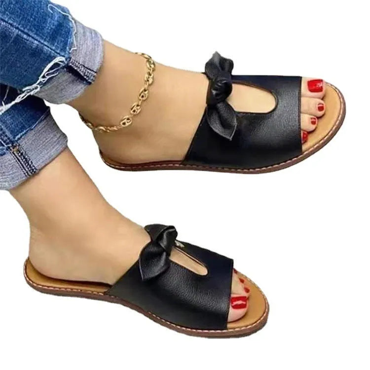 Ladies fish mouth style sandals with a decorative bow, shown in black, pink, and gold colour options.