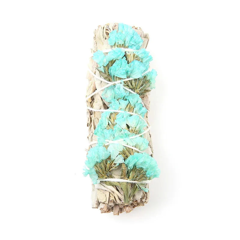 White sage and red rose petal colourful aromatherapy incense bundle on a wooden table