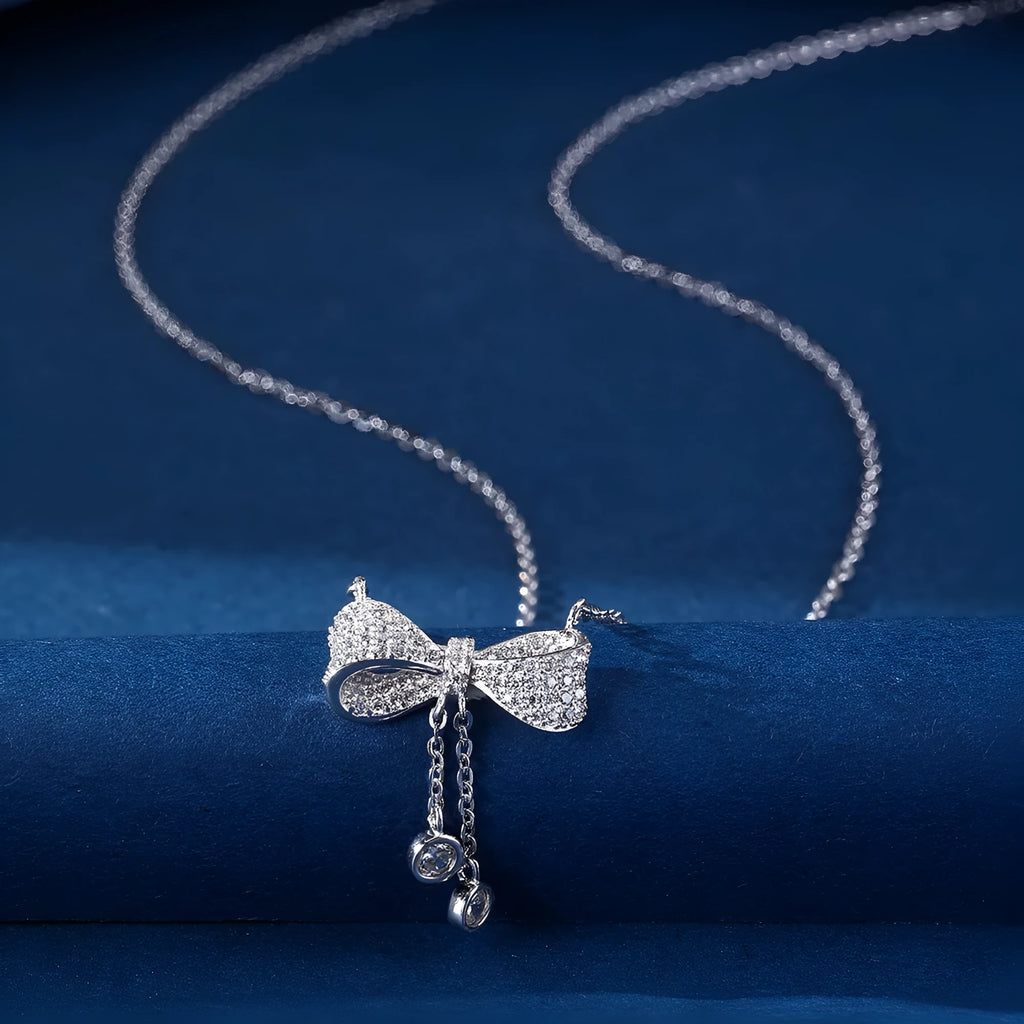 S925 sterling silver necklace with a bow pendant on an O-ring chain.