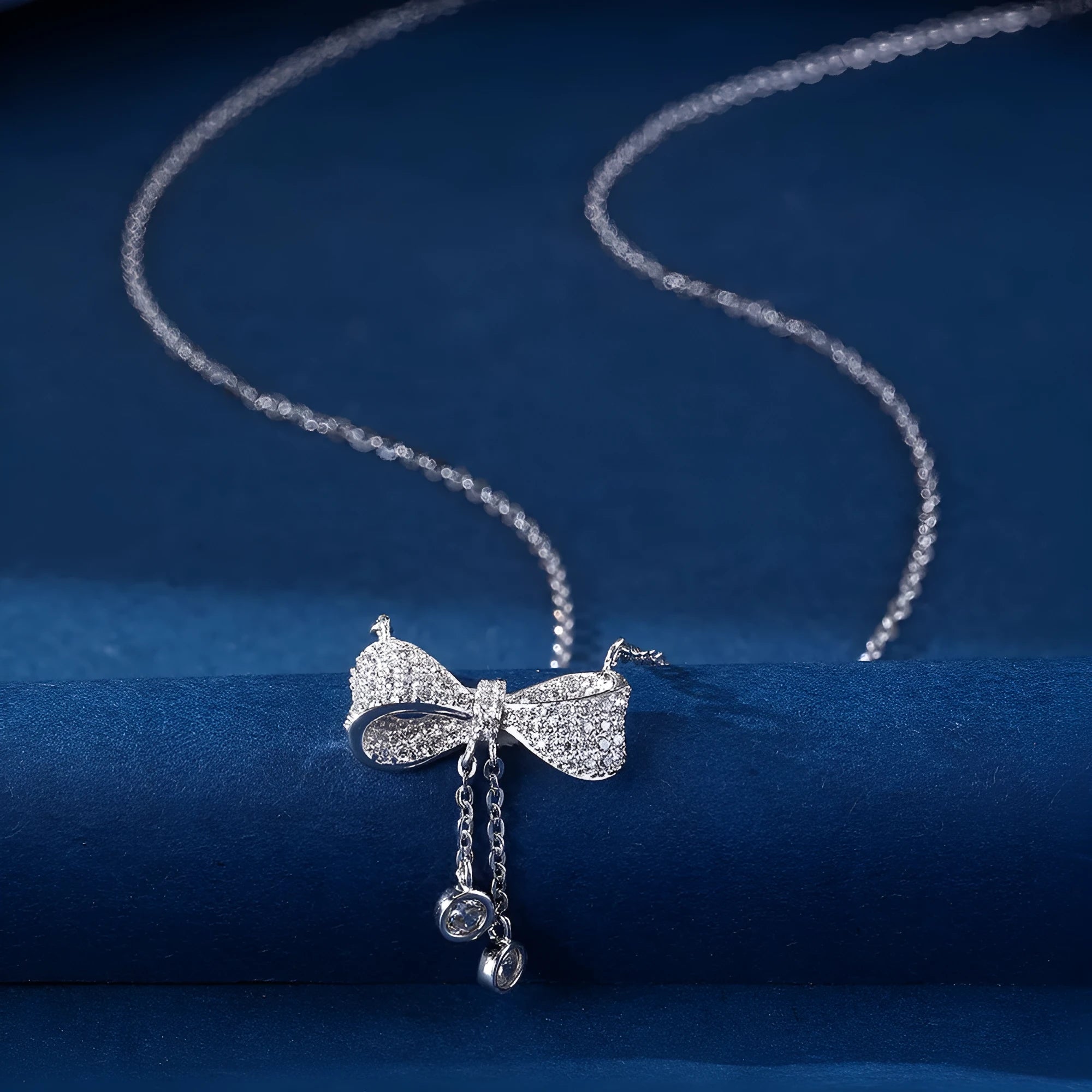 S925 sterling silver necklace with a bow pendant on an O-ring chain.