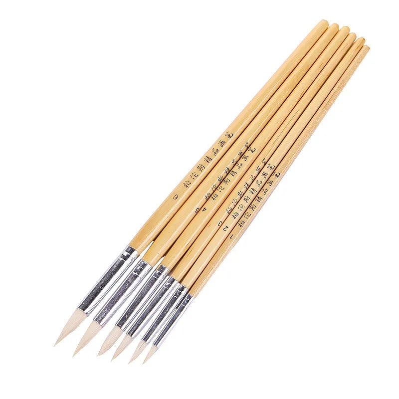 Set of six wooden-handled artistic brushes with pointed tips for calligraphy and watercolour painting.