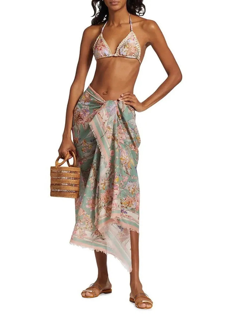 Women's creamy-white floral bikini set with separate skirt on beach