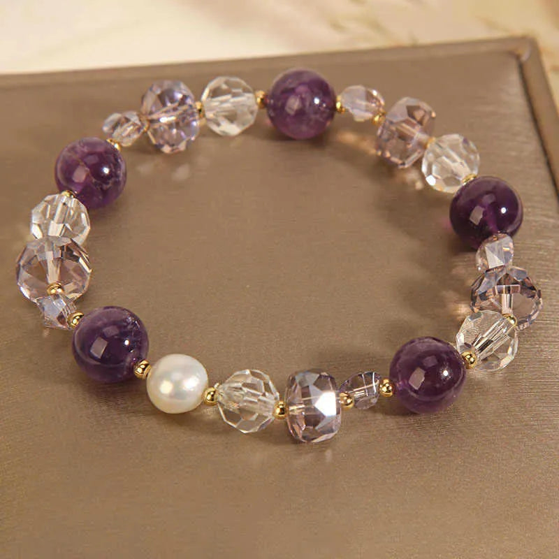 Women's U-shaped artificial amethyst bracelet with pearl and four-leaf clover charm on wrist
