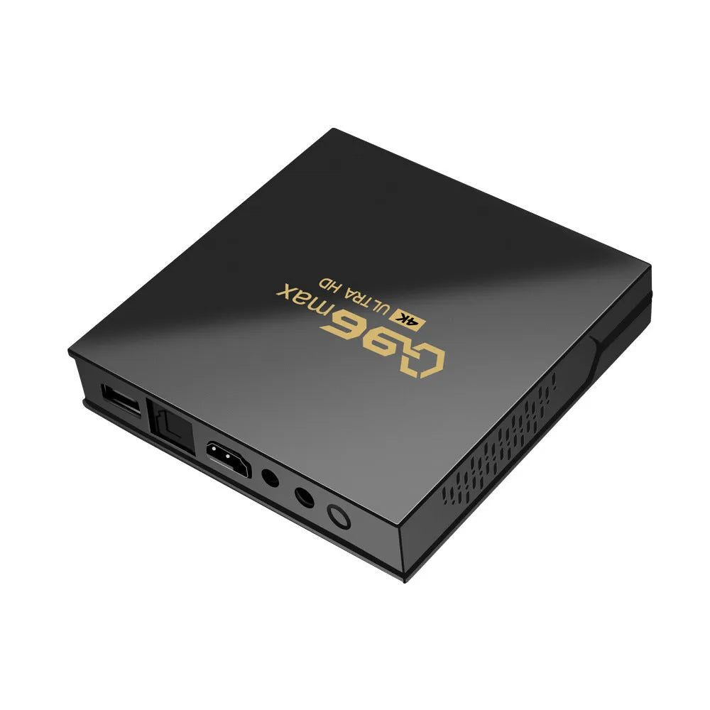 Q96 MAX S905 Android 4K TV Box set-top unit with remote control on a table.