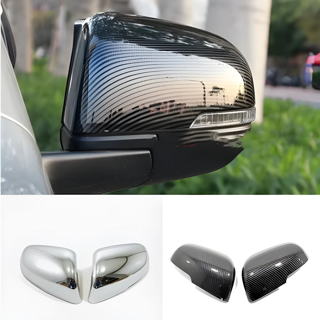 A pair of plastic rearview mirror protection covers in a carbon fibre black finish.
