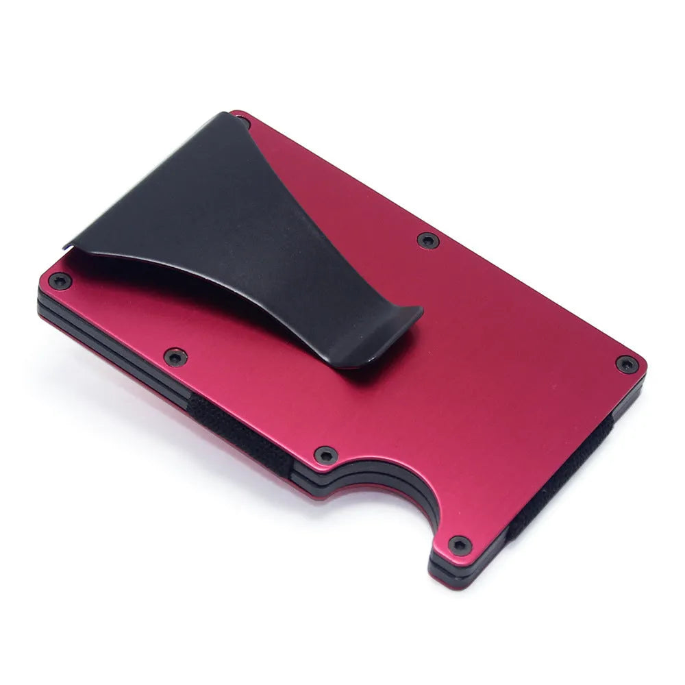 Geometric carbon fibre and aluminium business card holder, 8mm thick, on a table.
