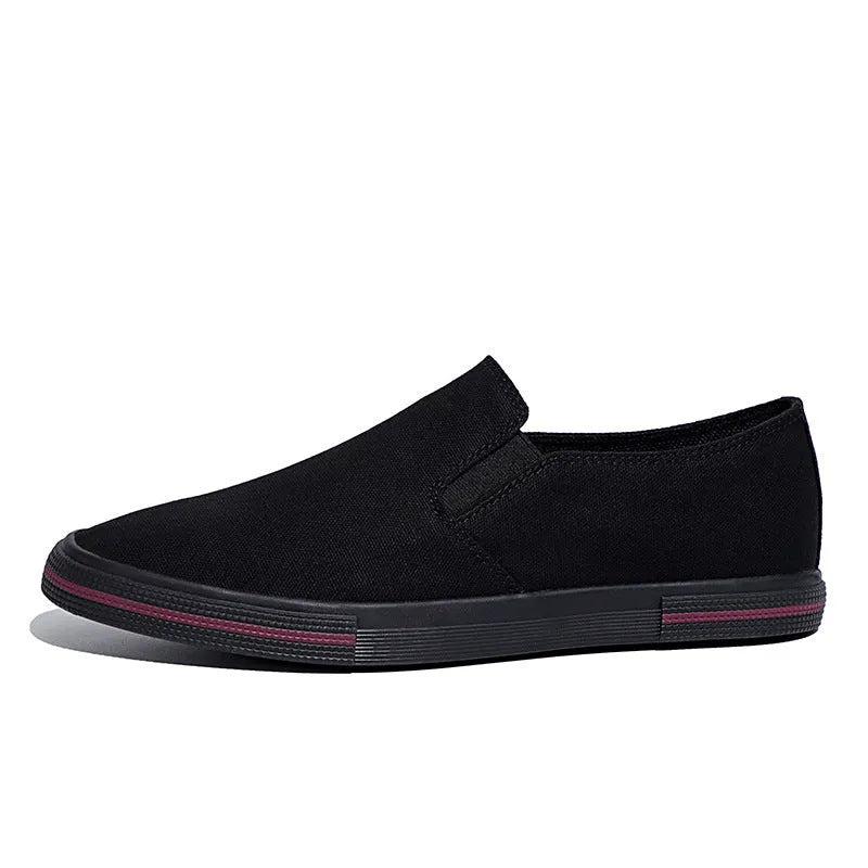 Canvas slip-on sneakers in khaki, grey green, or black with vulcanised rubber sole.