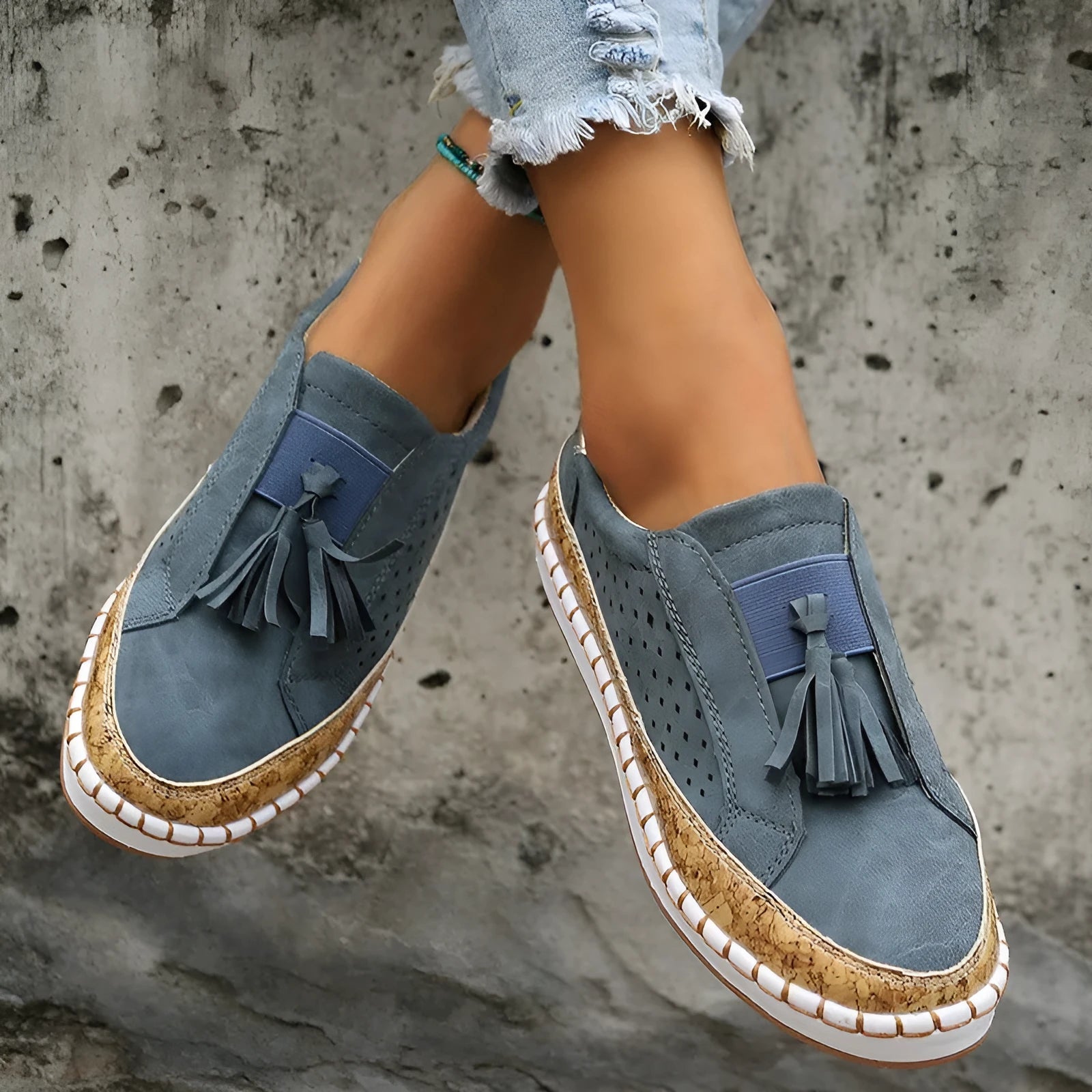 Women's tassel flats loafers in black with round toe, low heel, and cross strap detail