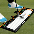 Black neoprene golf swing stance training pad on a green surface.