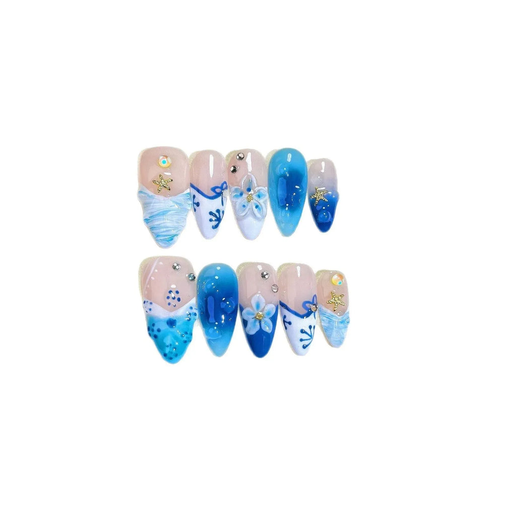 Blue hand-painted carved transparent fake nails set in sizes XS, S, M, L.