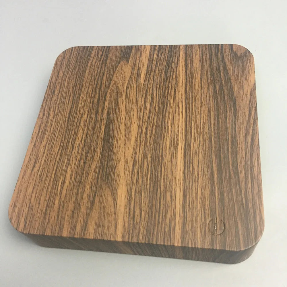 Square walnut coloured levitating moon lamp with galaxy design hovering above a circular base.