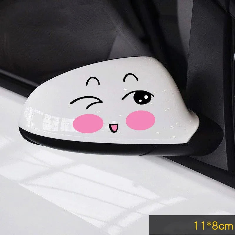 Pair of reflective cartoon car stickers with cute eye designs on a white background.