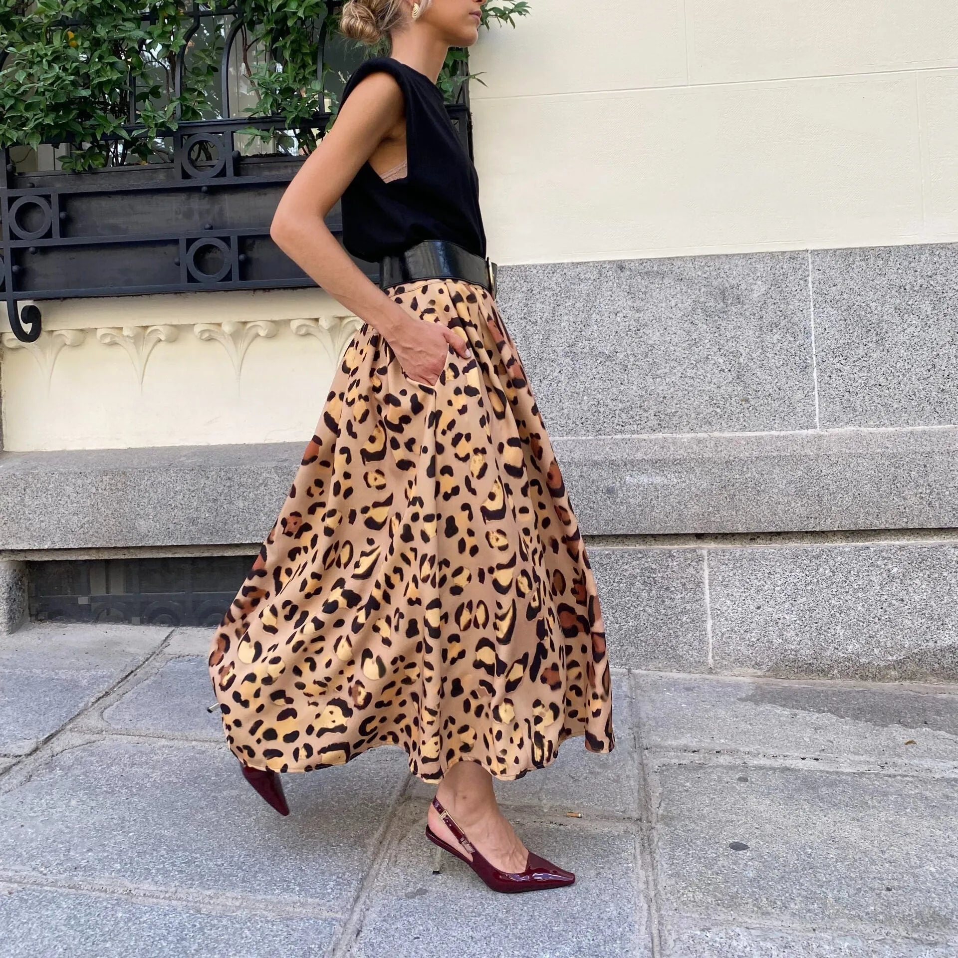 Brown leopard print women's long A-line skirt with a big hem, made from polyester fabric.