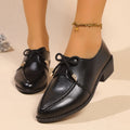 Women's casual leather shoes with a decorative bow on a pointed toe, showcasing a rubber sole.