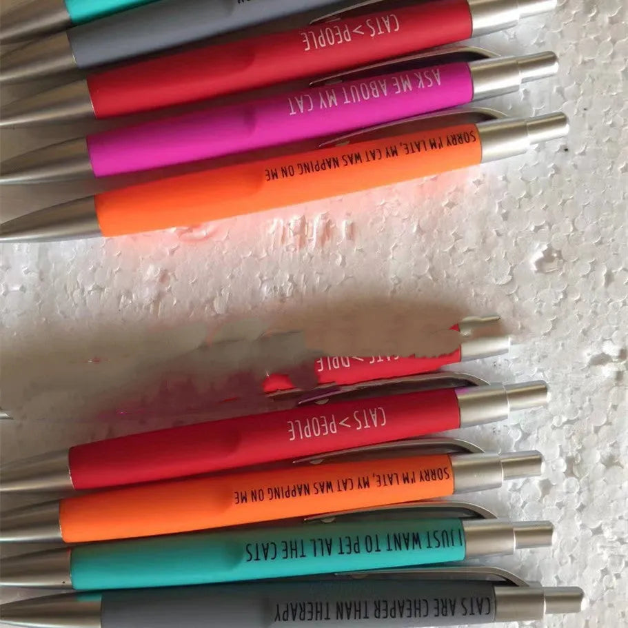 Set of five coloured push action automatic pens and a beaded storage bag