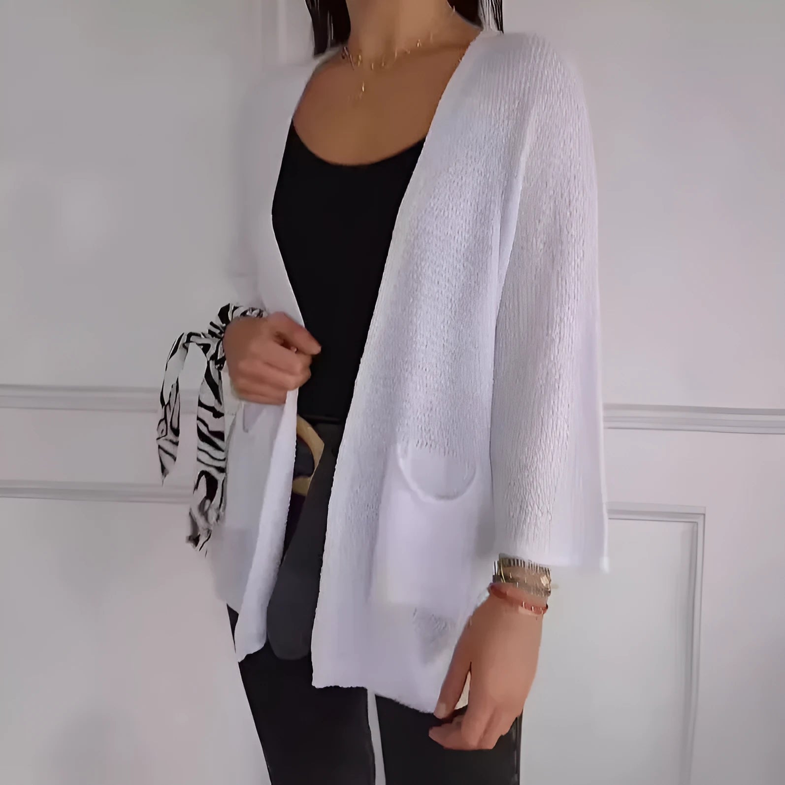 Women's longline waffle-textured cardigan coat in army green, showing pocket detail and nine-quarter sleeve length.