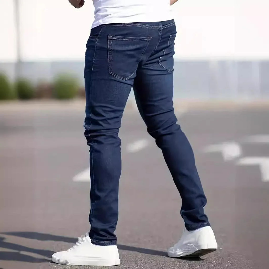 Men's dark blue slim fit casual jeans with a mid-waist and skinny leg style.