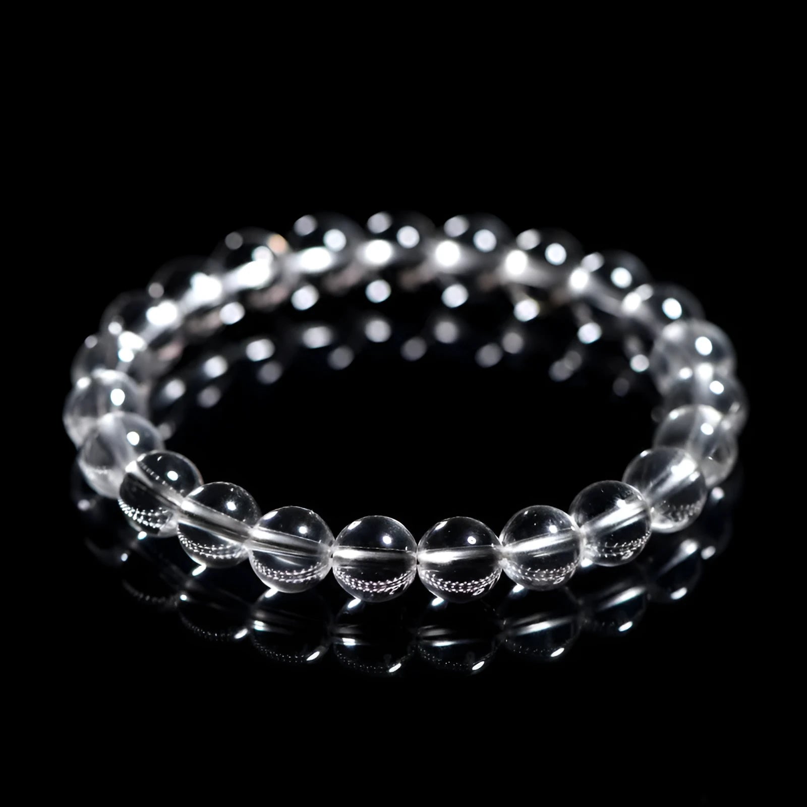 Natural Donghai old materials white crystal geometric bracelet with round beads on a wrist.