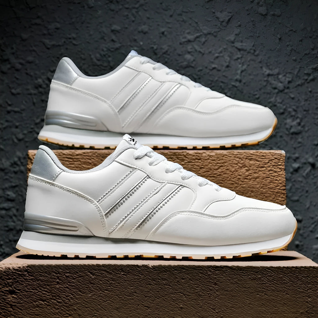 Men's black casual running shoes with a white carved wing pattern on the leather upper.