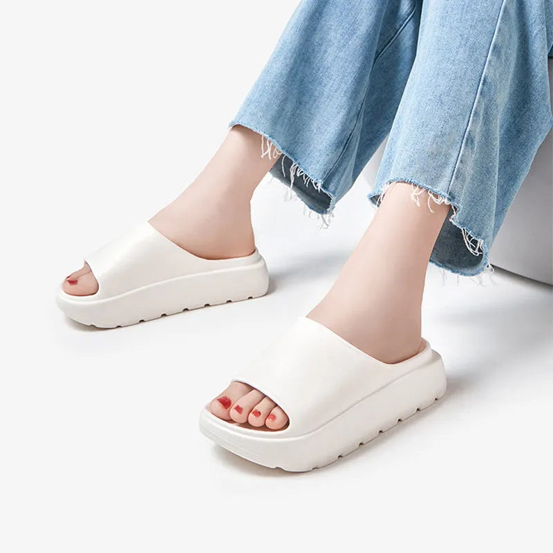 Women's thick-soled beige EVA beach slippers with a fish mouth design.