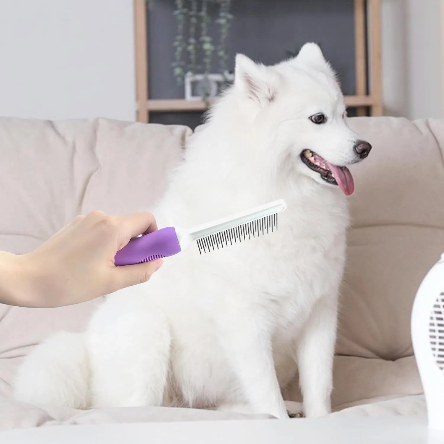 Purple pet detangling comb with stainless steel teeth and ergonomic handle for dogs and cats.