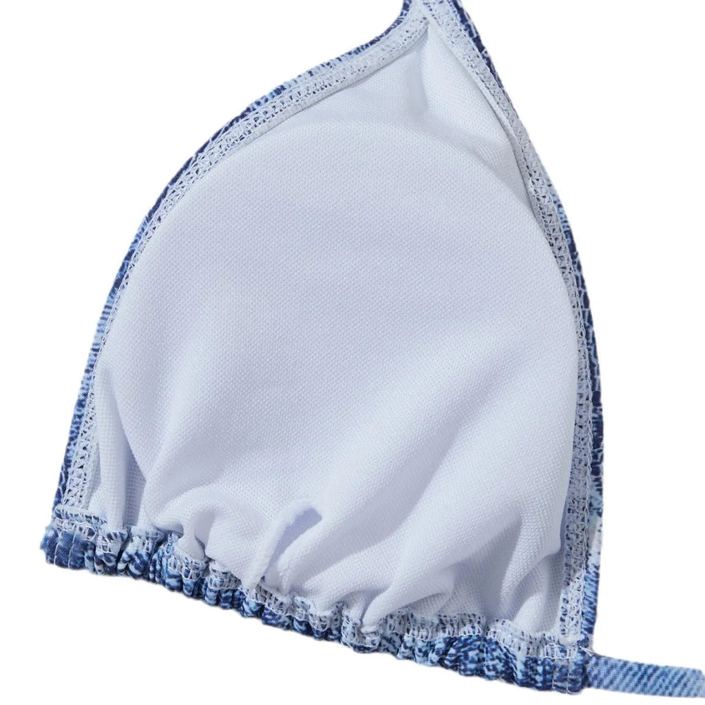 Denim blue printed women's bikini set with strap design on a white background.