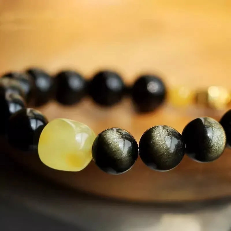 Golden obsidian bracelet with 10mm geometric zodiac beads on adjustable cord