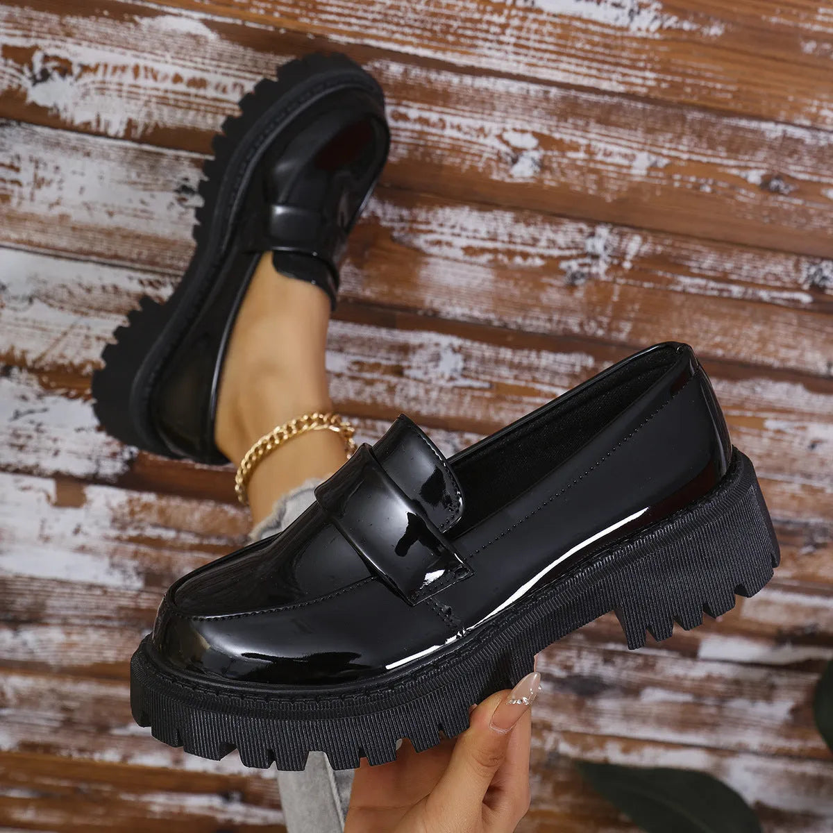 Plus size women's black slip-on loafers with a chunky platform heel and thick rubber sole.