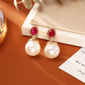 High-grade ruby pearl stud earrings with real gold plating in red colour on copper base