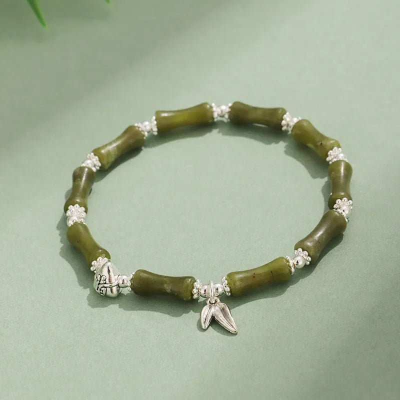 Green aventurine bamboo strawberry quartz crystal bracelet with mixed natural stones on wrist