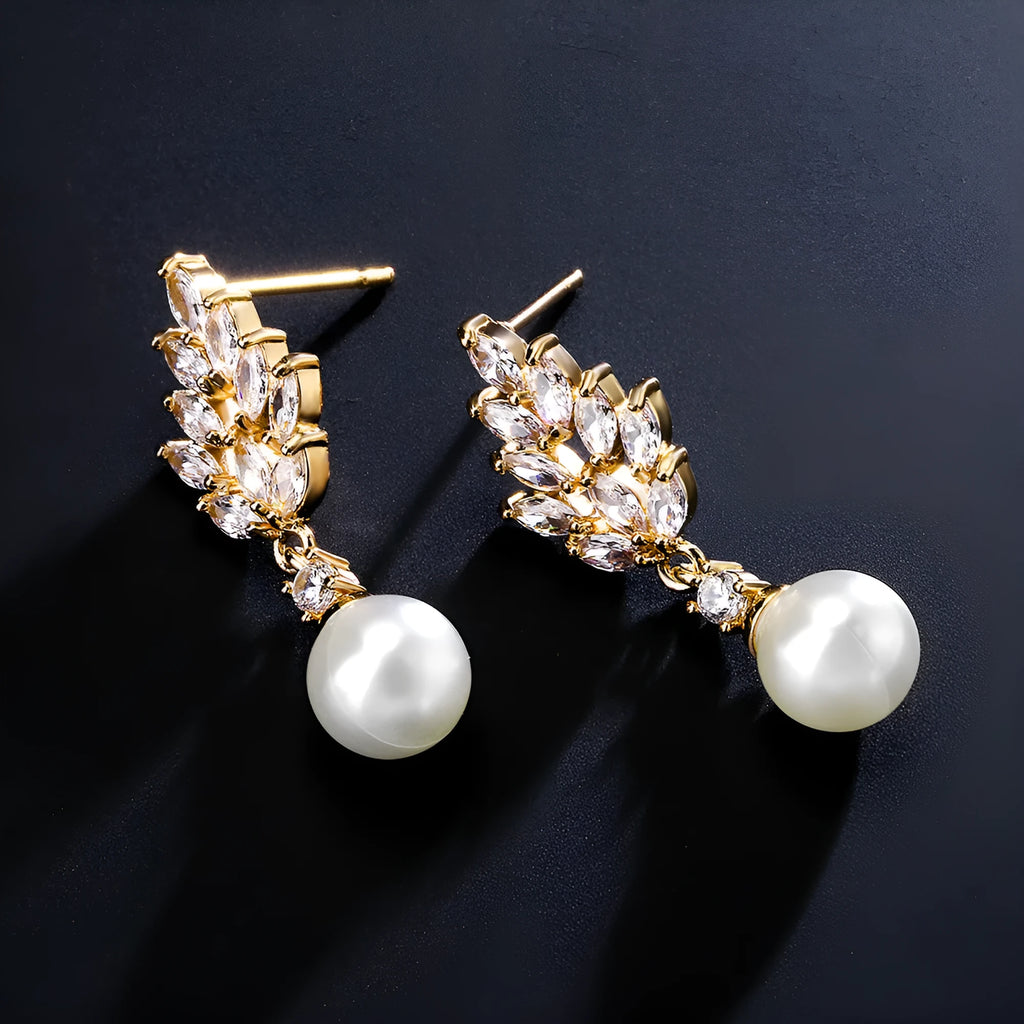 Geometric flower-shaped earrings with micro-inlaid zircon stones and pearl accents in gold, platinum, or rose gold plating.