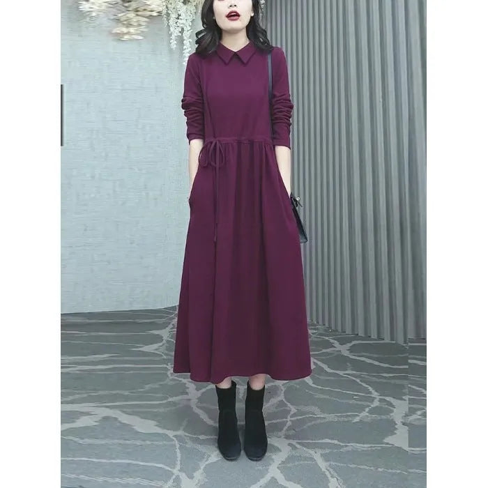 A purplish red long sleeve plus size dress for women, shown with extra-long sleeves and a long skirt.