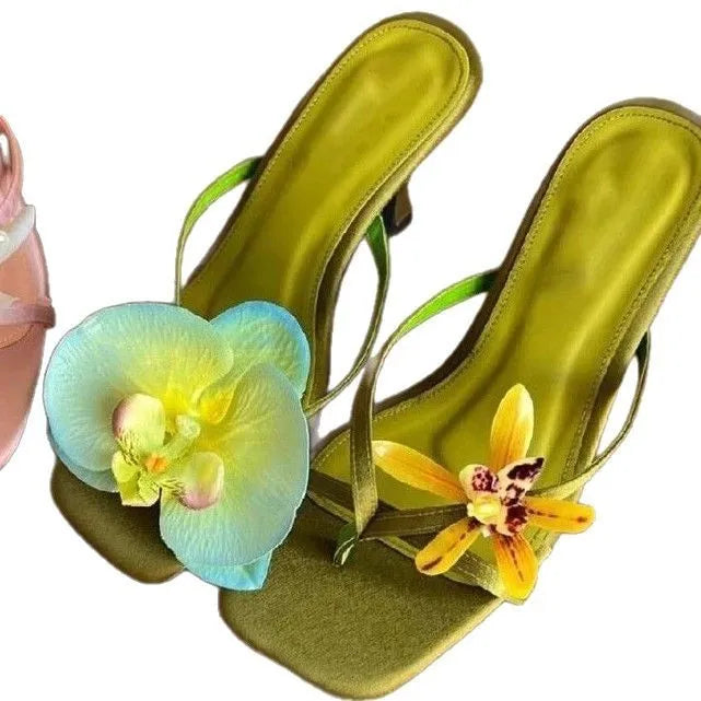 Handmade women's high-heel sandals with an asymmetric flower design on a calf leather upper.