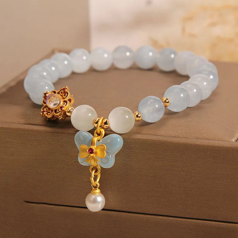 Aquamarine butterfly pendant crystal bracelet for women with rhinestone details on silver chain.