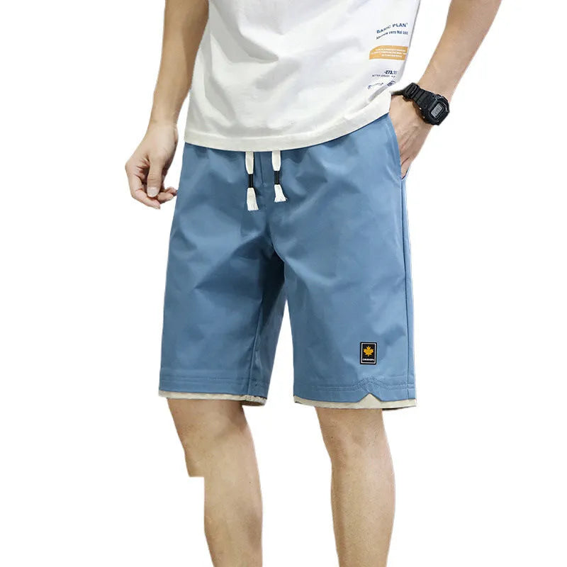 Man's loose-fit straight-leg casual shorts in green, shown for beachwear.