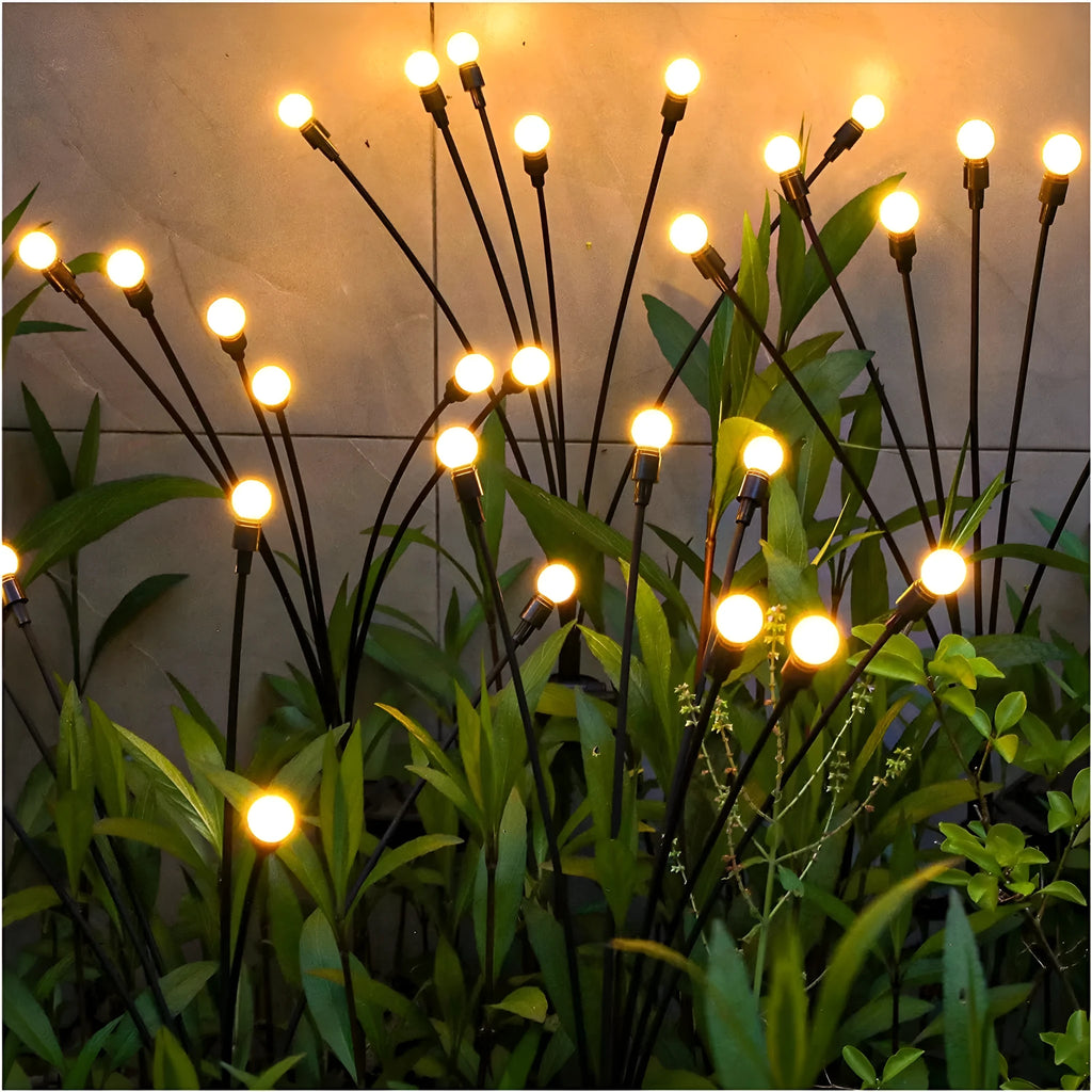 Solar-powered LED firefly garden light with multiple heads and a ground stake.