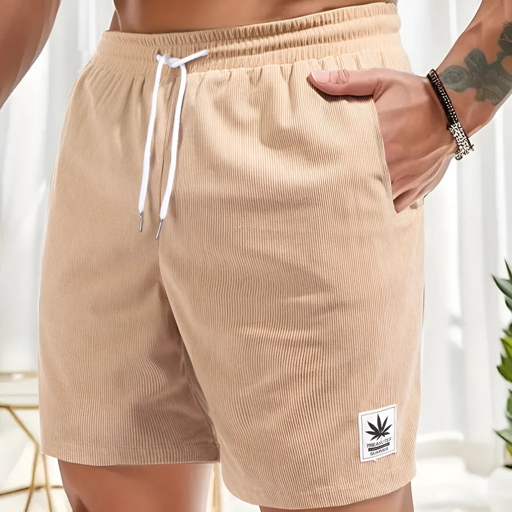 Man wearing grey straight leg drawstring summer shorts made from elastic fabric.