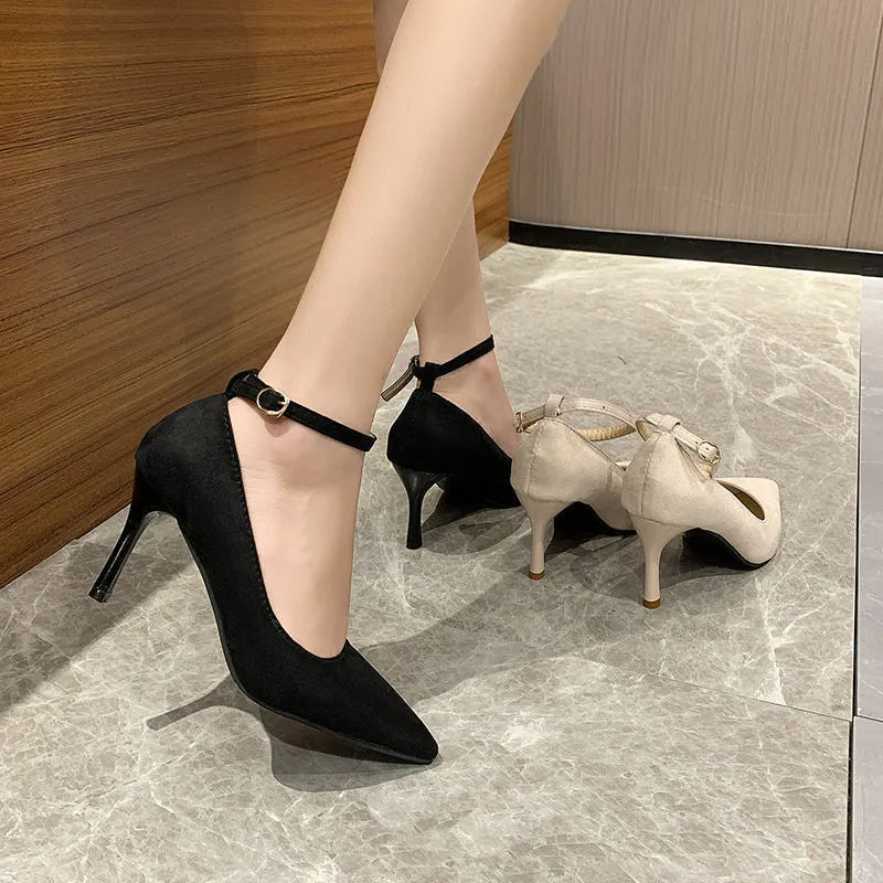 Black and white women's stiletto high heel shoes with skull pattern and ankle buckle.