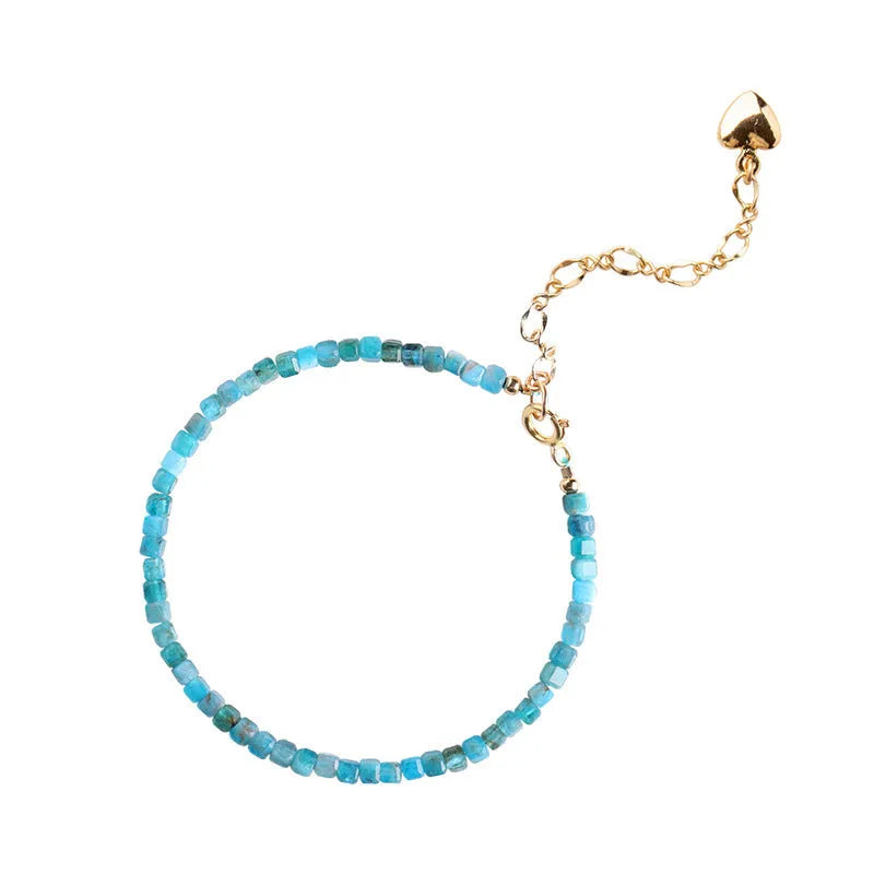 Women's blue and grey crystal bracelet with diamond faceted beads on a wrist.