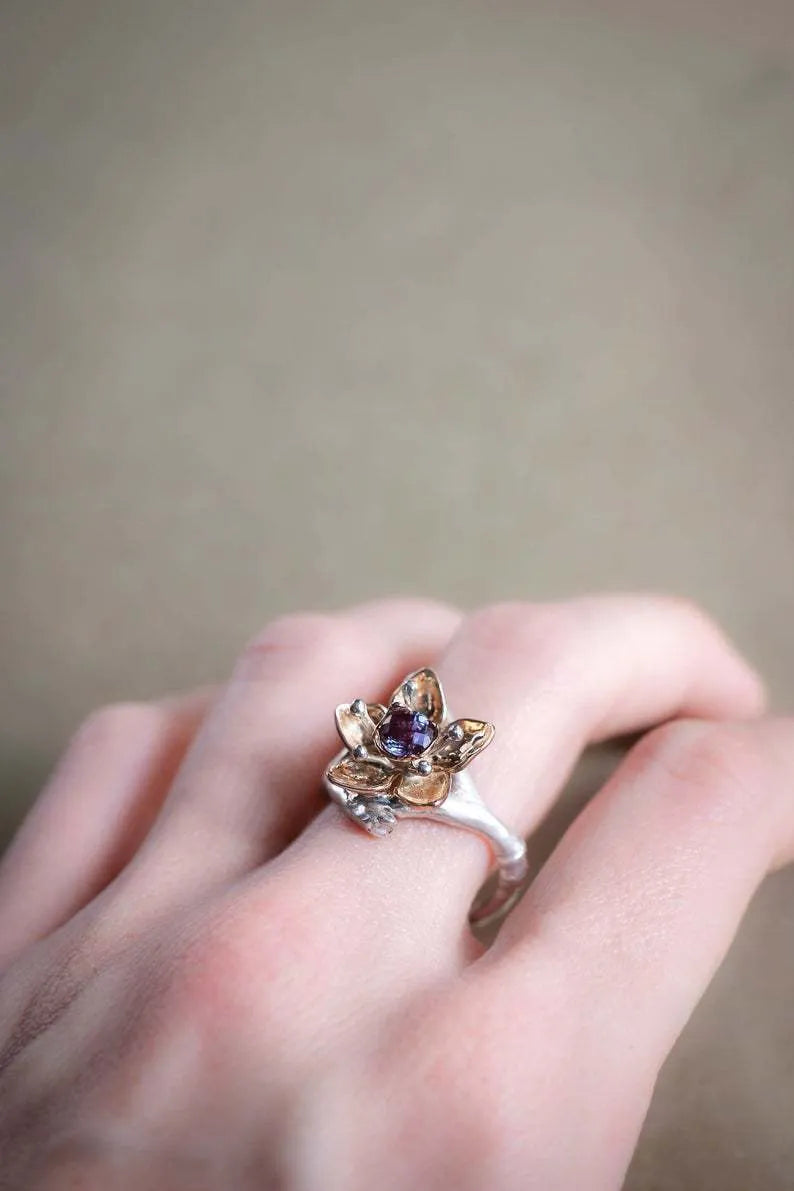 Silver two-tone floral geometric pattern alloy ring for women on a white background.