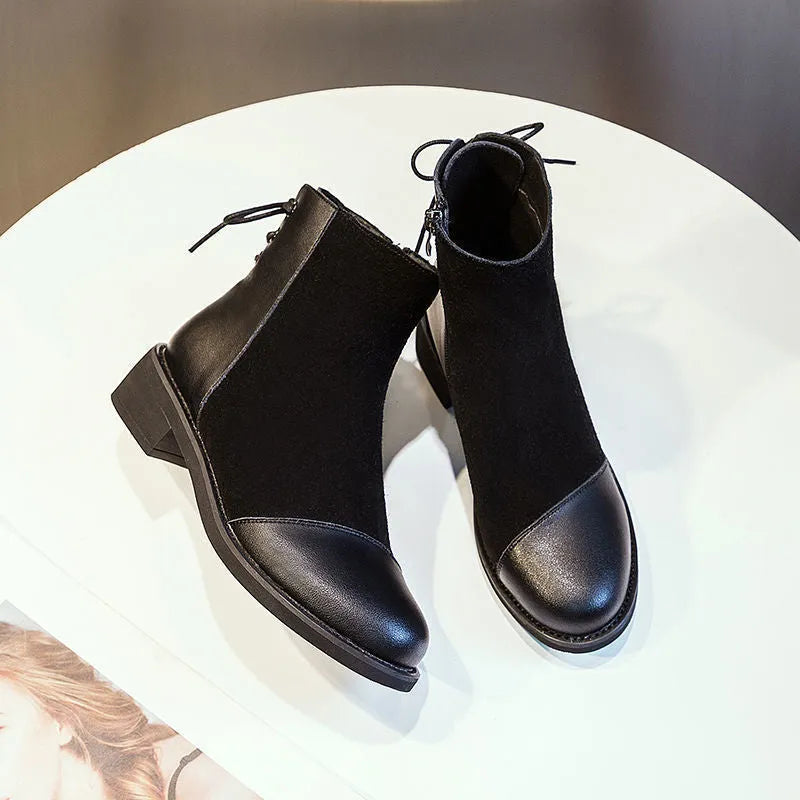 Women's black Martin boots with side zipper, non-slip rubber soles, and decorative bow detailing