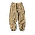 Black cotton tapered casual pants with ankle tie and large pocket.