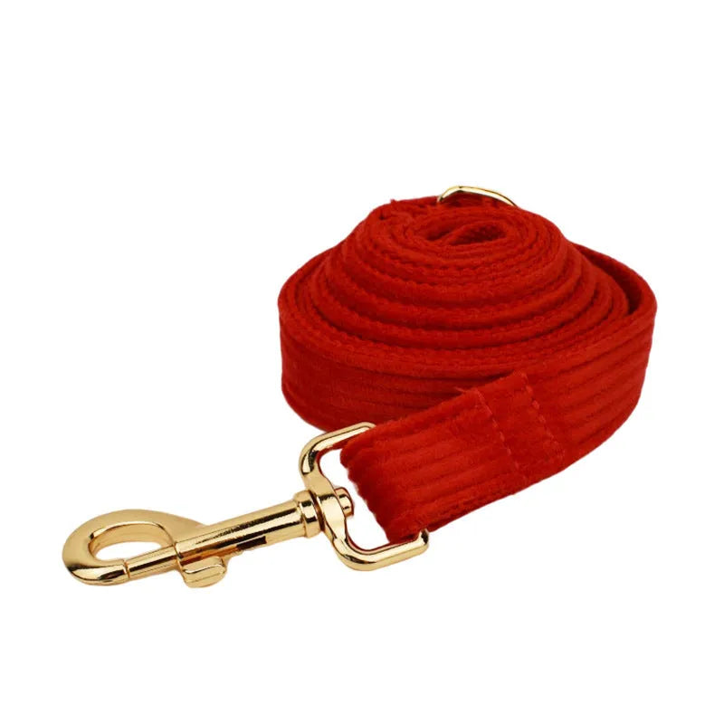 Red corduroy dog collar and matching traction rope set with vest, bow, and poop bag accessories