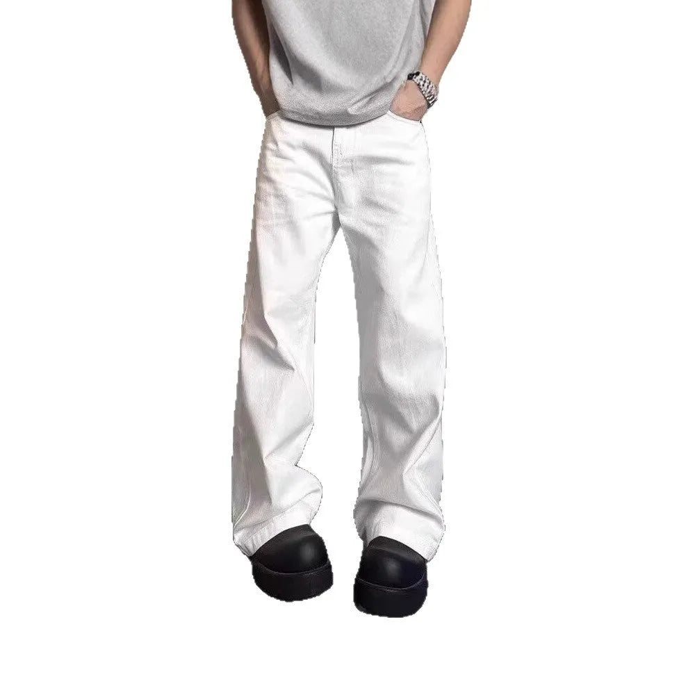 Men's loose fit straight wide leg white cotton denim jeans on a mid waist, showing zipper fly.