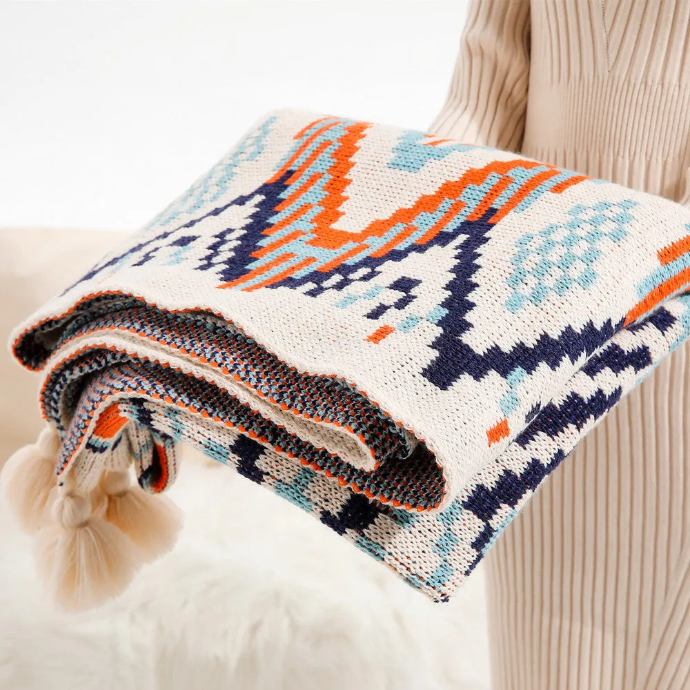 Acrylic bohemian-style blanket with tassel trim in a geometric pattern colour option