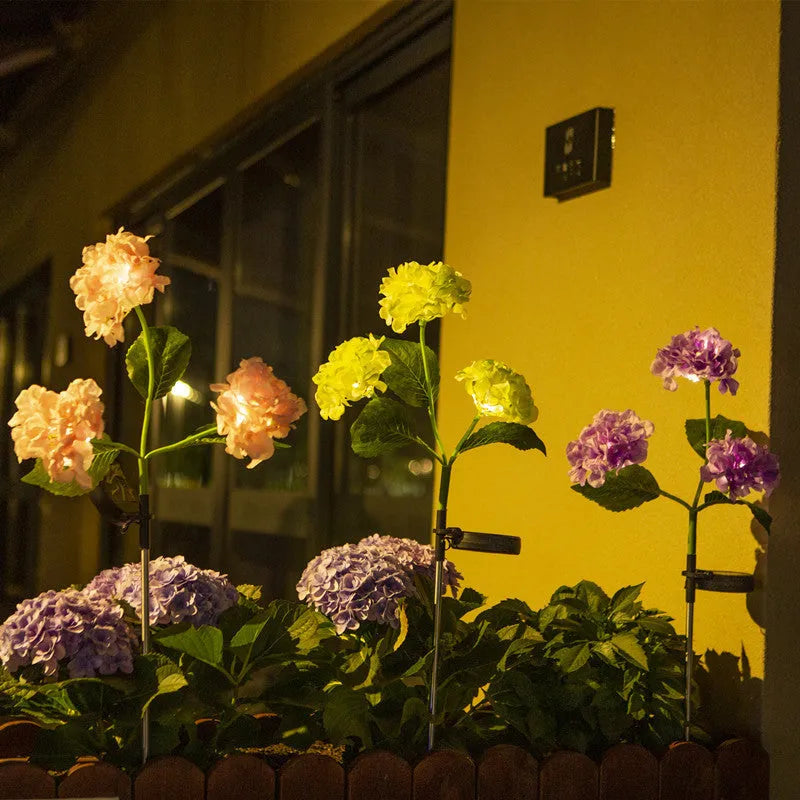Solar hydrangea garden lights with plant-shaped design and floor outlet base in outdoor setting