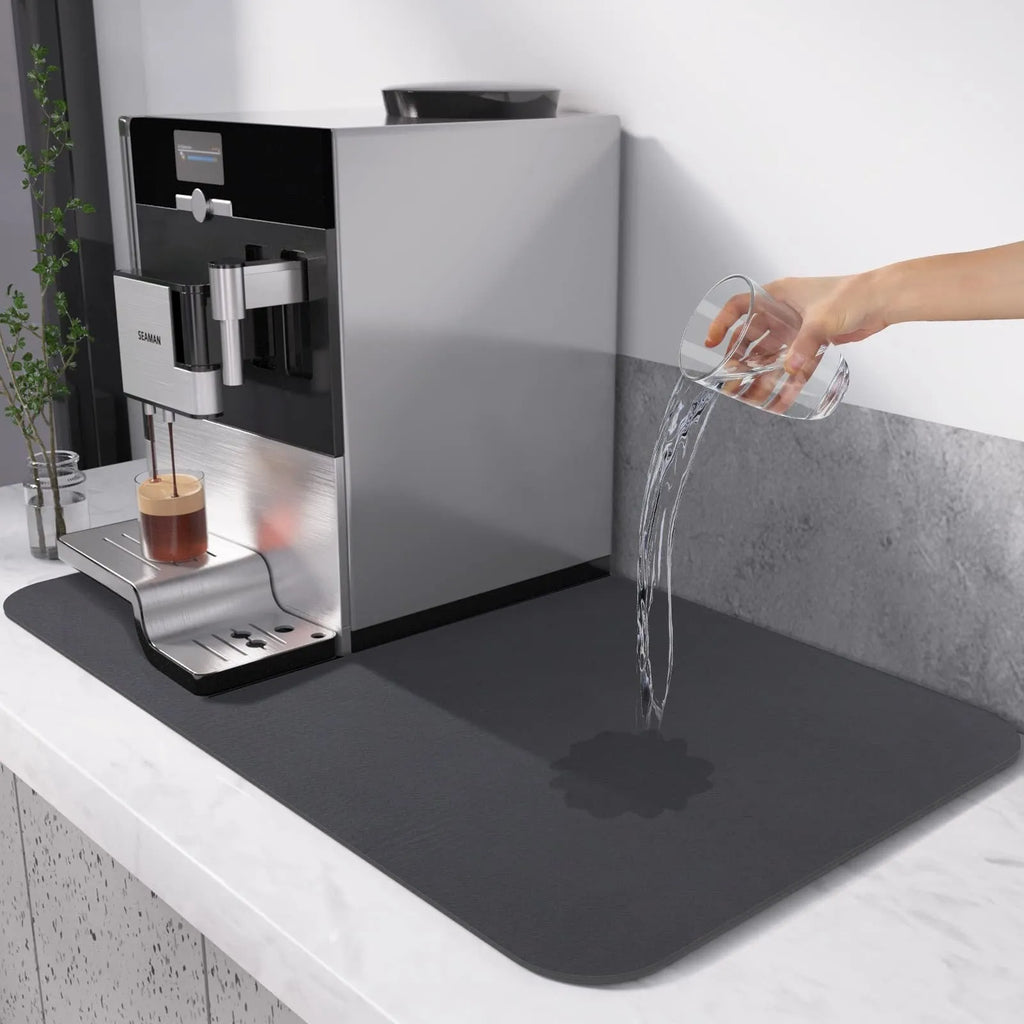Black square super absorbent PU leather kitchen drain pad drying mat with anti-slip backing on a countertop.