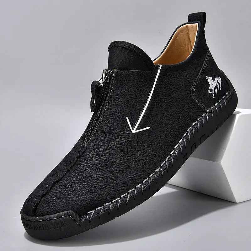 Men's black leather ankle boots with front zipper and round toe on rubber sole